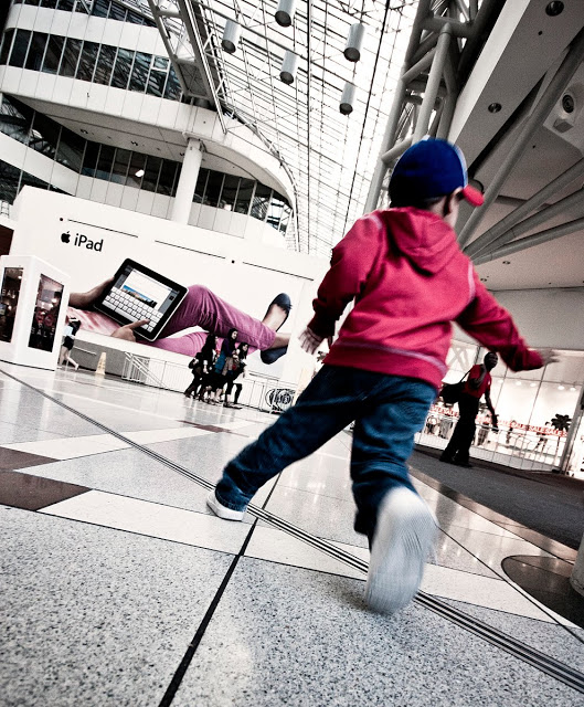 A child running through the Eaton Centre at the North Entrance