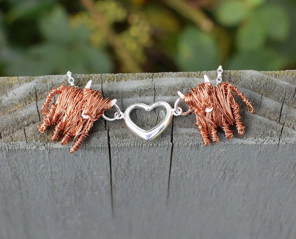 Highland cow necklace love moo flat on fence smaller.jpg