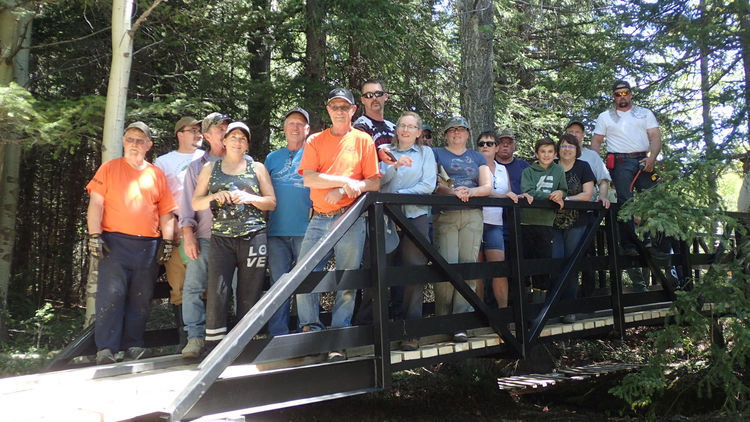 Volunteers from the Crowsnest Pass Quad Squad and the finished OHV Bridge