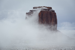 The fog clears to reveal Merrick Butte in Monument Valley, Ariz.