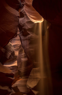 Sand spills down into Upper Antelope Canyon outside Page, Arizona.