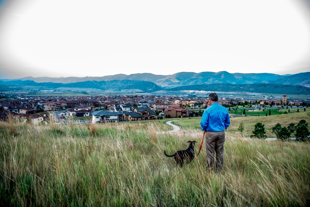 Andrew and his dog overlooking beautiful Solterra and the foothills