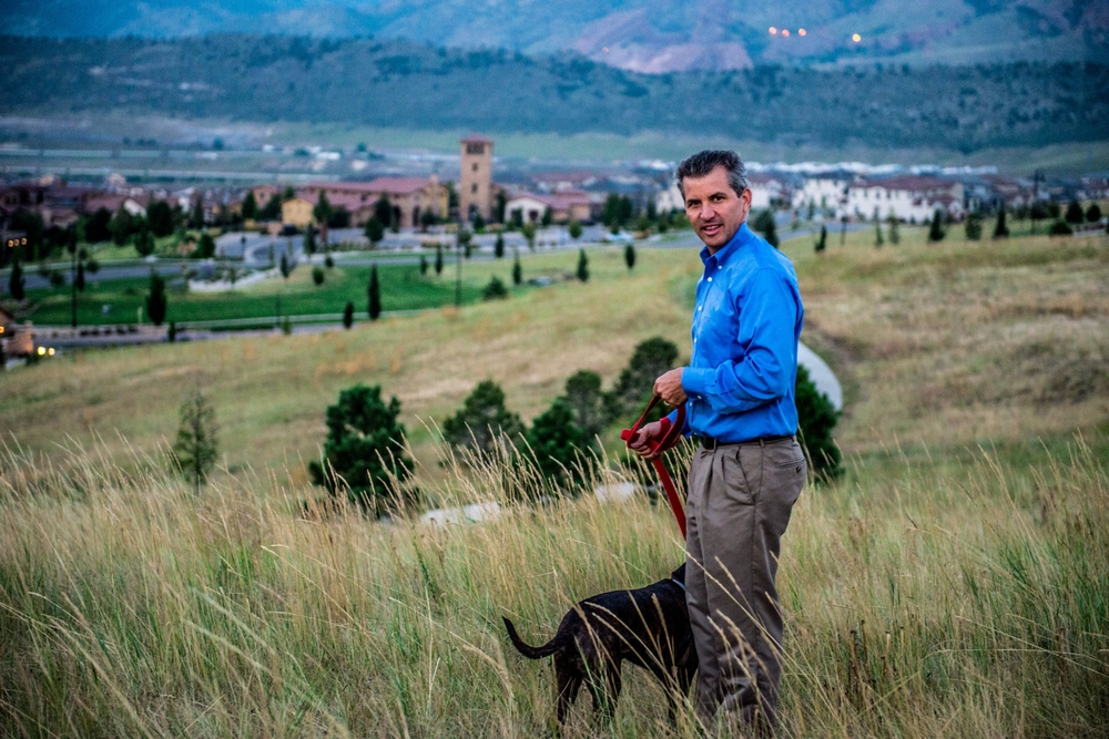 Re/Max realtor Andrew Nagel with his dog in the open space overlooking Solterra