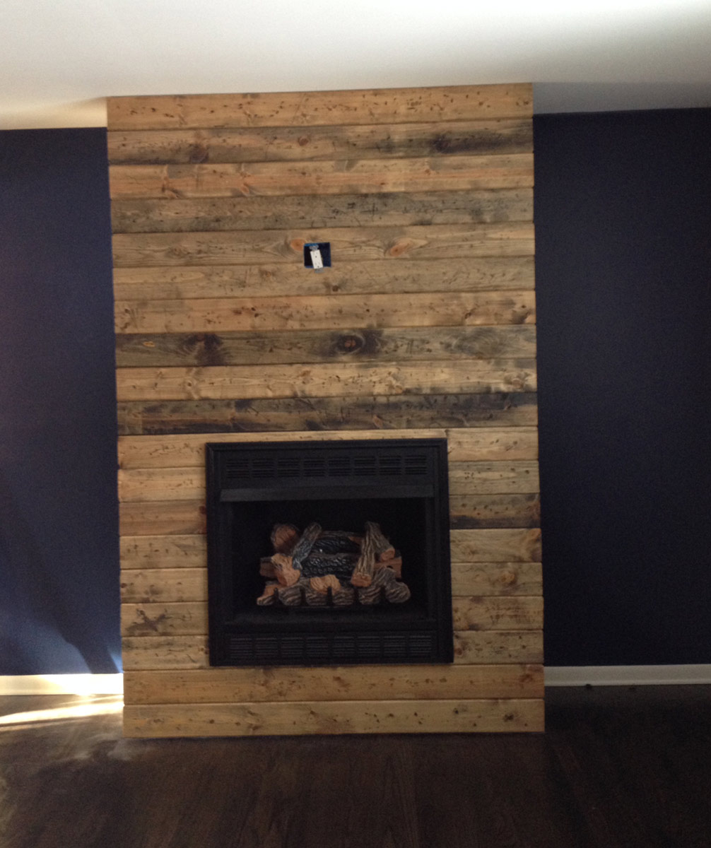 Looking for that ever so popular rustic look but don’t know how or where to  get genuine reclaimed boards? We were able to build a reclaimed wood  fireplace surround for under $100!  Here’s how we did it!