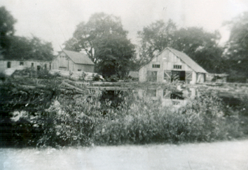  This image, contributed to The Tweed News by Mrs. Lorraine Shea of Tweed, shows Lost Channel as it appeared in the 1940s. The sawmill is the building to the right. The centre building housed the waterwheel. Broom handles and cheese boxes for the area’s many cheese factories were produced in the building to the left. This once busy industrial site also contained a gristmill and a veneer-making building, both of which lay outside the reach of this photograph.