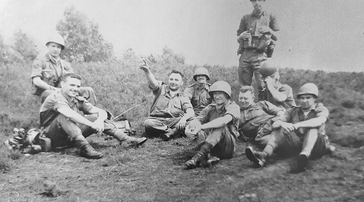 Earl Pearson (pointing), shown on maneuvers. His military career started with the Hastings Prince Edward Regiment, and he was later transferred to the 1st Canadian Guards and then the Royal Canadian Regiment. Photo courtesy the Pearson Family