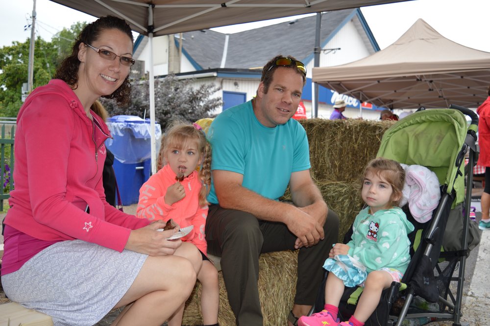 The Bergsma family from Frankford take a snack break at last year’s Water Buffalo Festival on Mill Street in Stirling. Despite occasional rain showers the event drew well over 2,500 people.