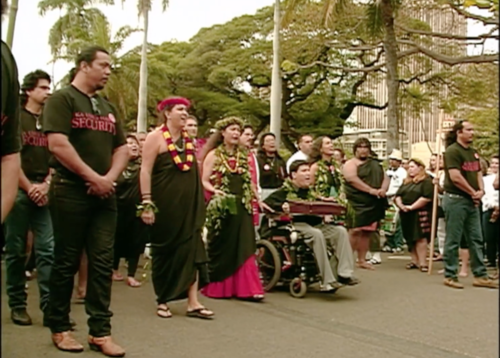 A group of activists march in Honolulu, lead by Kanalu Young.