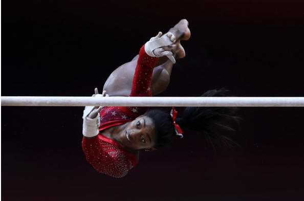 Simone Biles on uneven bars as she led the U.S. to team gold at the World Championships. (Getty Images)