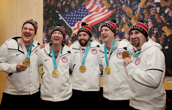 Curling gold medalists Matt Hamilton, John Shuster, John Landsteiner, Tyler George and Joe Polo celebrate at USA House. (Getty Images)
