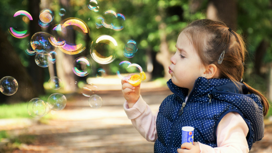 girl blowing bubbles.png