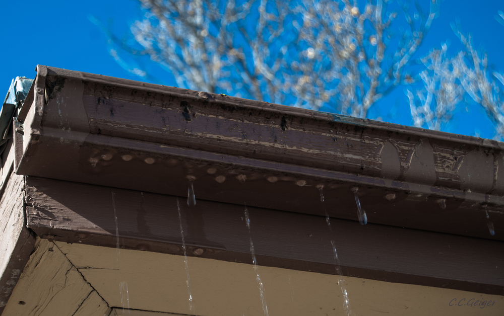 How can I clear a clogged downspout?