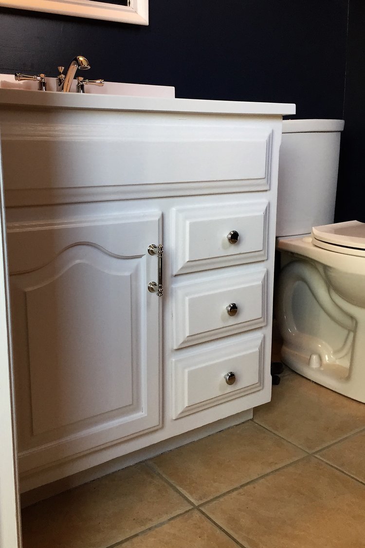 The builder grade vanity is updated with white paint and new hardware.