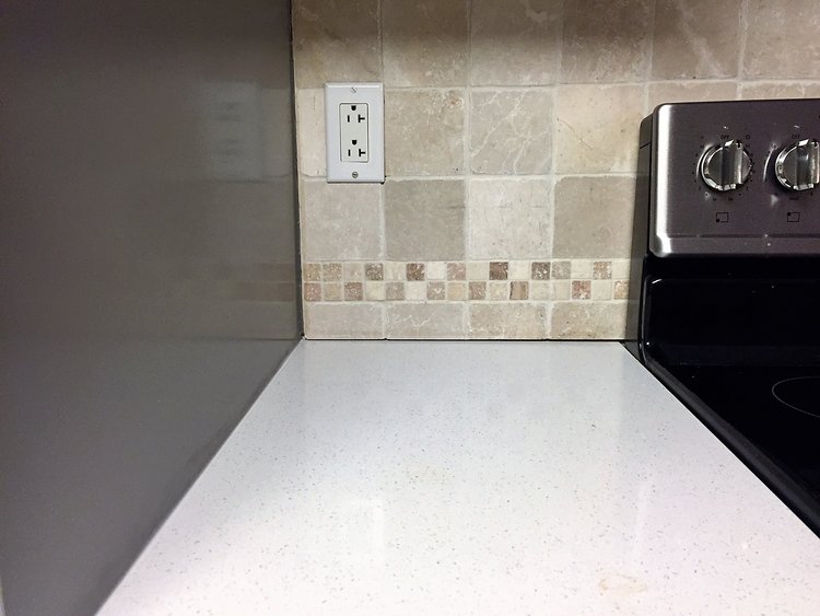 You can see in this picture the visible seam between the tile and counter.