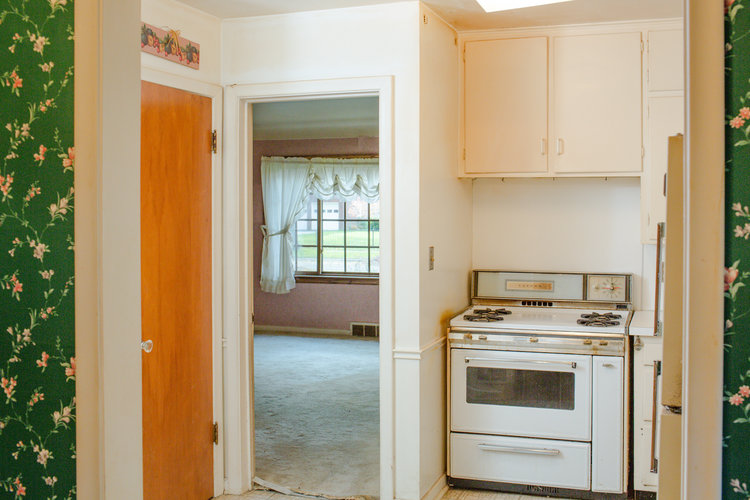 Small kitchen at the flip house before renovations