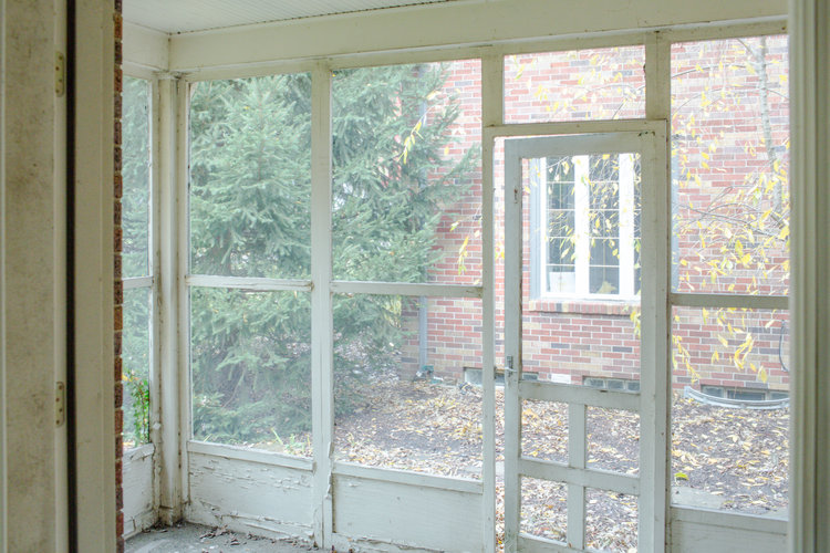 Weathered and peeling screened in porch