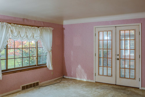 Before front room with pink wallpaper and dating window treatments