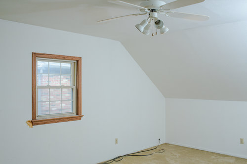 Before, the walls were cracked and dirty, the carpet was old and the ceiling fan was dated.