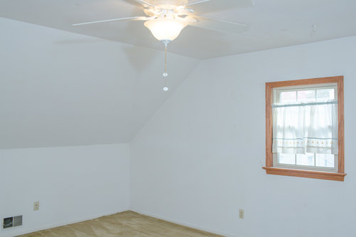 Before, the second bedroom was dated and dingy