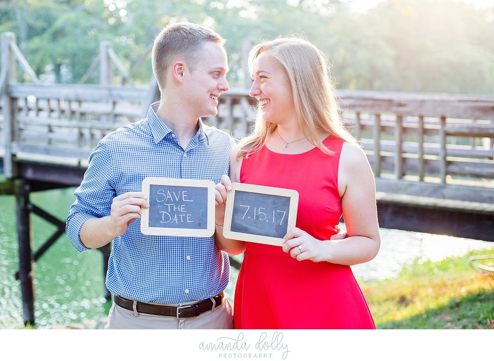 Couple holding Save The Date Sign