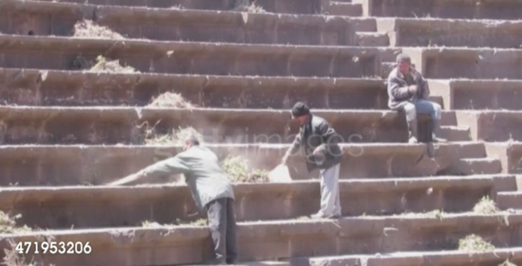 A scene from the video release by Bosra al-Sham’s local council showing residents cleaning the steps of the ancient amphitheater as part of the restoration process. 