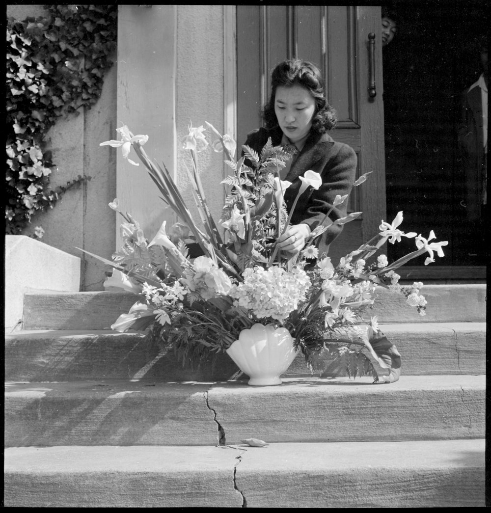  Oakland, California. Arranging flowers for alter on last day of service at Japanese Independent Congregational Church, prior to evacuation. Evacuees of Japanese ancestry will be housed at War Relocation Authority centers for the duration. 