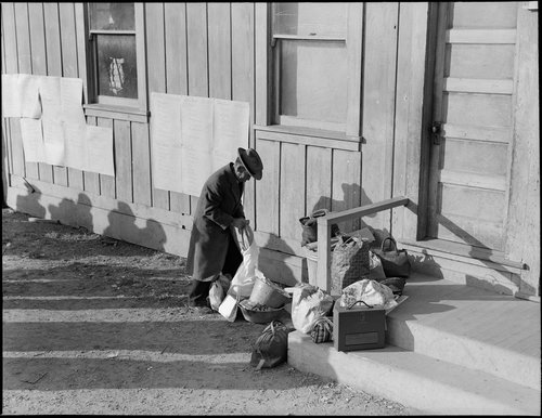  Centerville, California. This farmer rearranges his personal effects as he awaits evacuation bus. Evacuees of Japanese ancestry will be housed in War Relocation Authority centers for duration. 