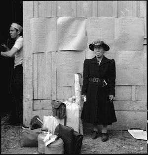  Centerville, California. This evacuee stands by her baggage as she waits for evacuation bus. Evacuees of Japanese ancestry will be housed in War Relocation Authority centers for the duration. 