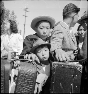  Turlock, California. These young evacuees of Japanese ancestry are awaiting their turn for baggage inspection at this Assembly center. 