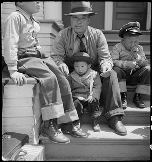  Oakland, California. Residents of Japanese ancestry waiting for evacuation buses which will take them to the Tanforan Assembly center under Civilian Exclusion Order Number 28. 