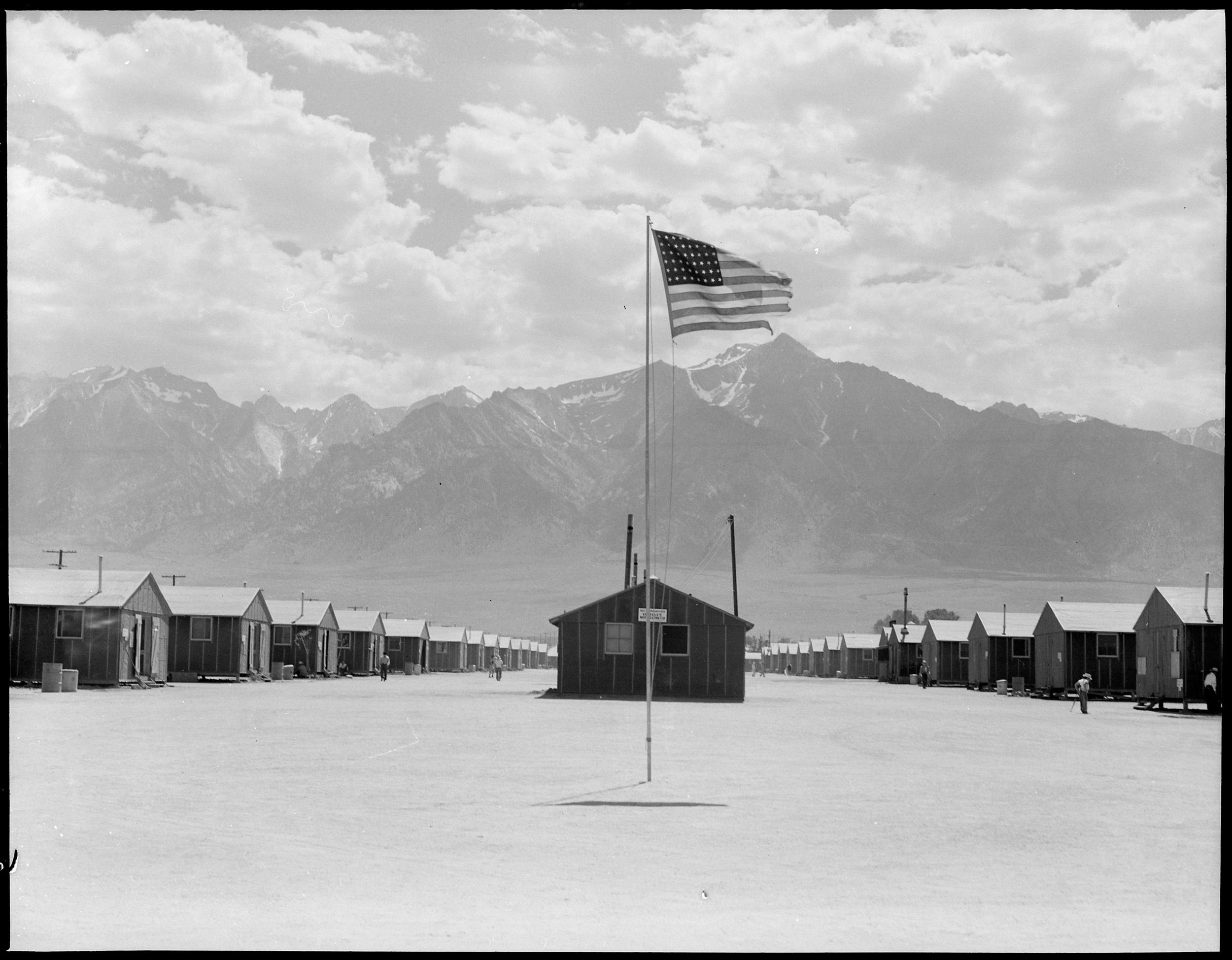 PRINT AVAILABLE July 3, 1942 — Manzanar Relocation Center, Manzanar, California. Street scene of barrack homes at this War Relocation Authority Center. The windstorm has subsided and the dust has settled.