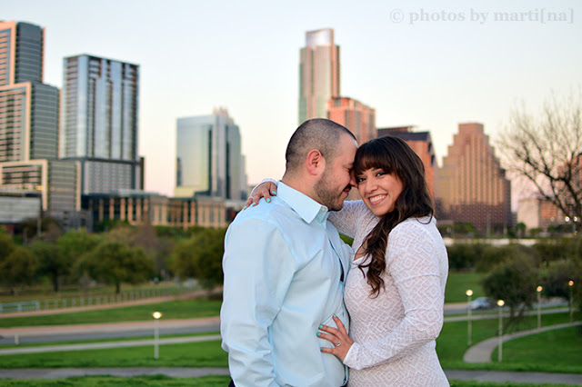 Engaged couple standing in front of downtown Austin, Texas