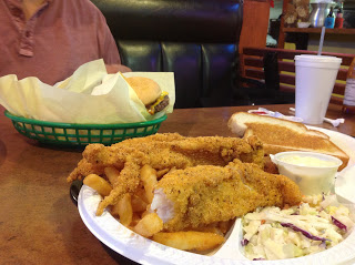 Fried Catfish, coleslaw, and a chili cheeseburger peaking out from behind the paper. And fries.