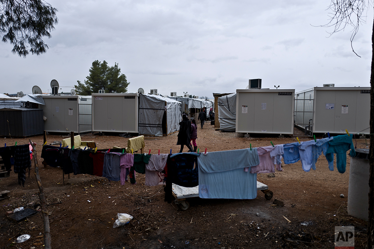 The laundry of a Syrian refugee family is hung out to dry near their shelter at the refugee camp of Ritsona about 86 kilometers (53 miles) north of Athens, Wednesday, Dec. 28, 2016. (AP Photo/Muhammed Muheisen)