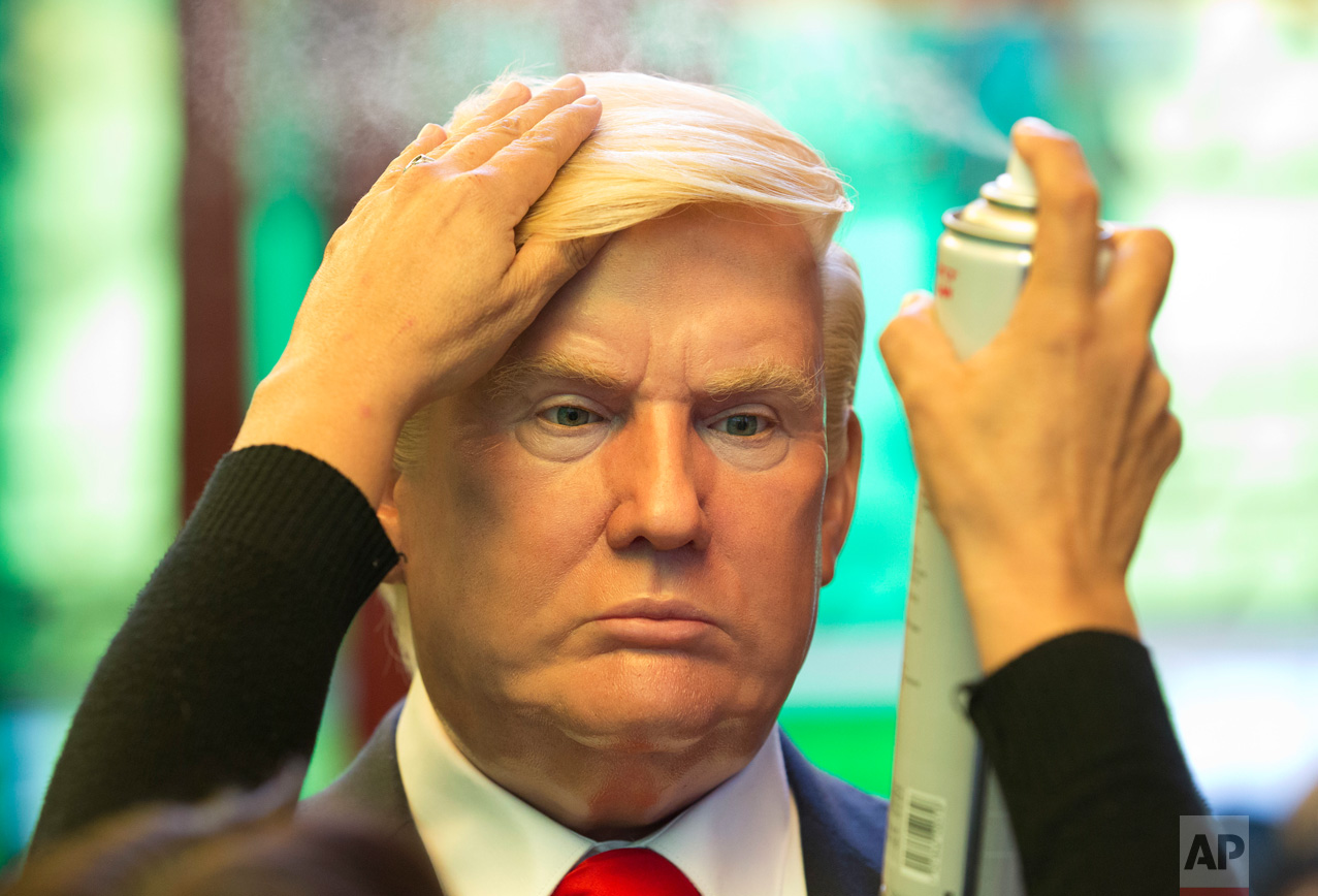 Museum worker Monica Alcantara adjusts the hair on a wax replica of U.S. President Donald Trump at the Wax Museum in Mexico City, Wednesday, Feb. 1, 2017. The wax figure of Trump went on display the day of his inauguration, Jan. 20, and currently stands next to Mexican President Enrique Pena Nieto at the museum's entrance. (AP Photo/Rebecca Blackwell)