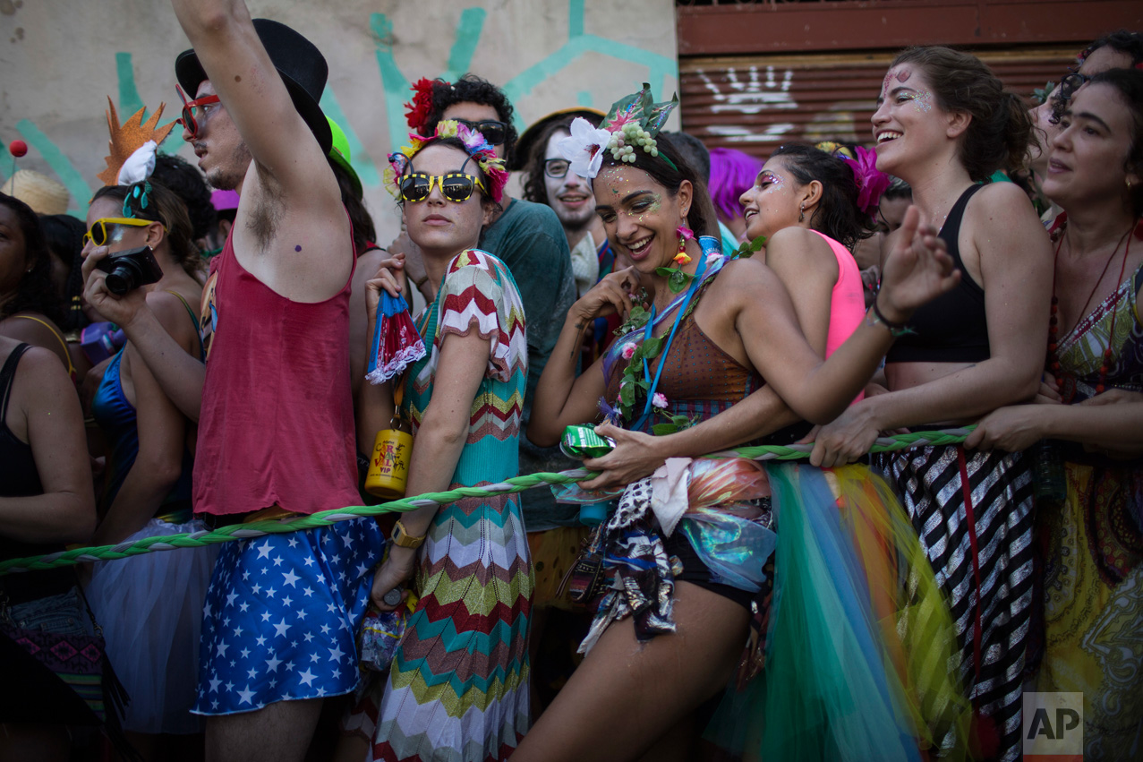 Revelers attend the Ceu na Terra, or 'Heaven on Earth' carnival street party in Rio de Janeiro, Brazil, Saturday, Feb. 18, 2017. Merrymakers take to the streets in hundreds of open-air "bloco" parties ahead of Rio's over-the-top Carnival, the highlight of the year for many. (AP Photo/Felipe Dana)