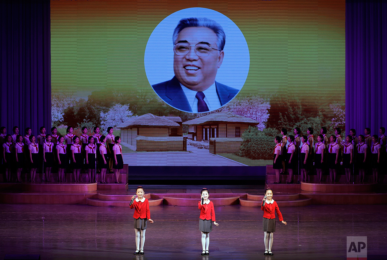 North Korean school children perform at the Mangyongdae Children's Palace while an image of their late leader Kim Il Sung is projected on a screen Friday, April 14, 2017, in Pyongyang, North Korea.  (AP Photo/Wong Maye-E)