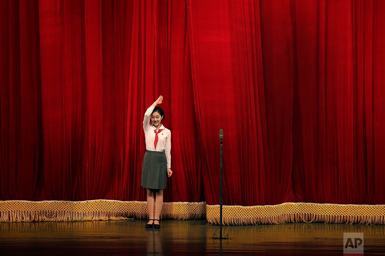 A North Korean student salutes the audience at the start of a performance at the Mangyongdae Children's Palace on Friday, April 14, 2017, in Pyongyang, North Korea. (AP Photo/Wong Maye-E)