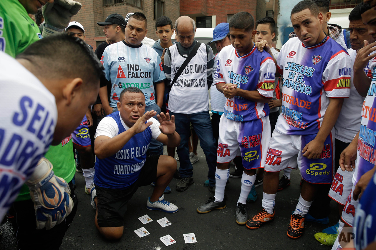 In this Monday, May 1, 2017 photo, coach Nestor Paredes huddles with his players before their semi-final game at the Little World Cup Porvenir street soccer championship in Lima, Peru. The wining team takes home this year’s trophy, a $2,500 cash prize and 12 pairs of soccer cleats. (AP Photo/Martin Mejia) 