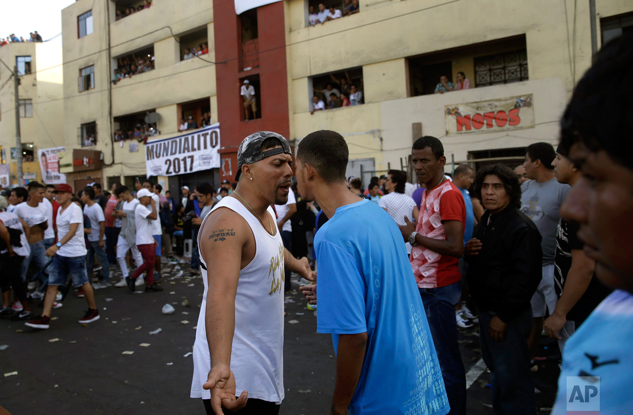  In this Monday, May 1, 2017 photo, fans of rival soccer teams argue at the end of the final game of Little World Cup of Provenir street soccer championship in Lima, Peru. The working-class neighborhood ritual in El Porvenir began in the 1950s as a challenge to the Manuel Odria military dictatorship when playing in the streets was forbidden. (AP Photo/Martin Mejia) 