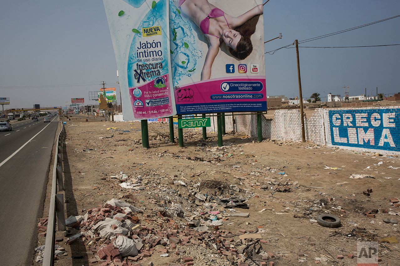 In this May 5, 2017 photo, a billboard advertising a soap brand stands among trash strewn along the Pan American Highway on the south side of Lima, Peru. Wilfredo Ardito, a law professor from the Pontifical Catholic University of Peru who has studied the country's racism, says that advertising in the Andean nation underscores its great inequalities, showing "the ideal world of happiness in which everyone is white and all of those who are not white have disappeared." (AP Photo/Rodrigo Abd)
