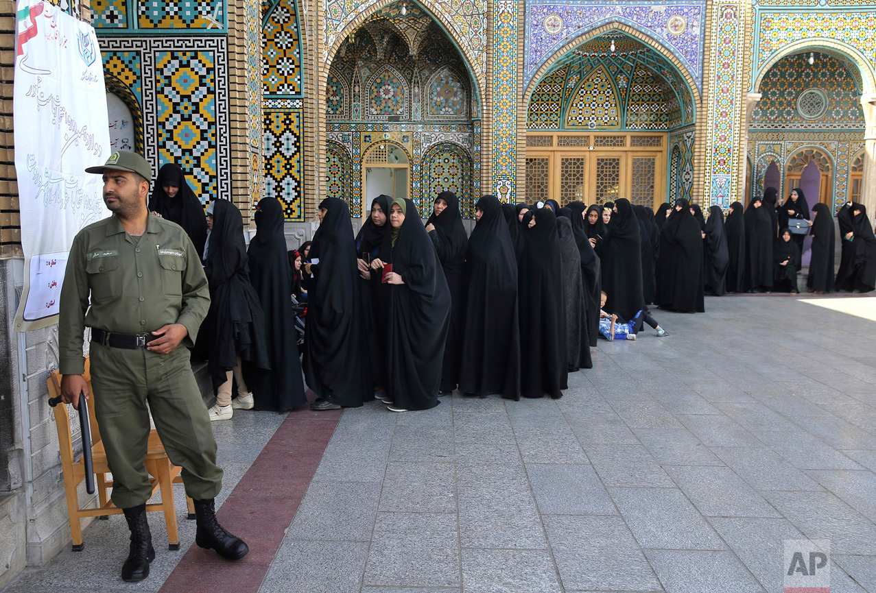 Female voters queue at a polling station for the presidential and municipal council election in the city of Qom, Iran, 78 miles (125 kilometers) south of the capital Tehran, Friday, May 19, 2017. Iranians began voting Friday in the country's first presidential election since its nuclear deal with world powers, as incumbent Hassan Rouhani faced a staunch challenge from a hard-line opponent over his outreach to the wider world. (AP Photo/Ebrahim Noroozi)