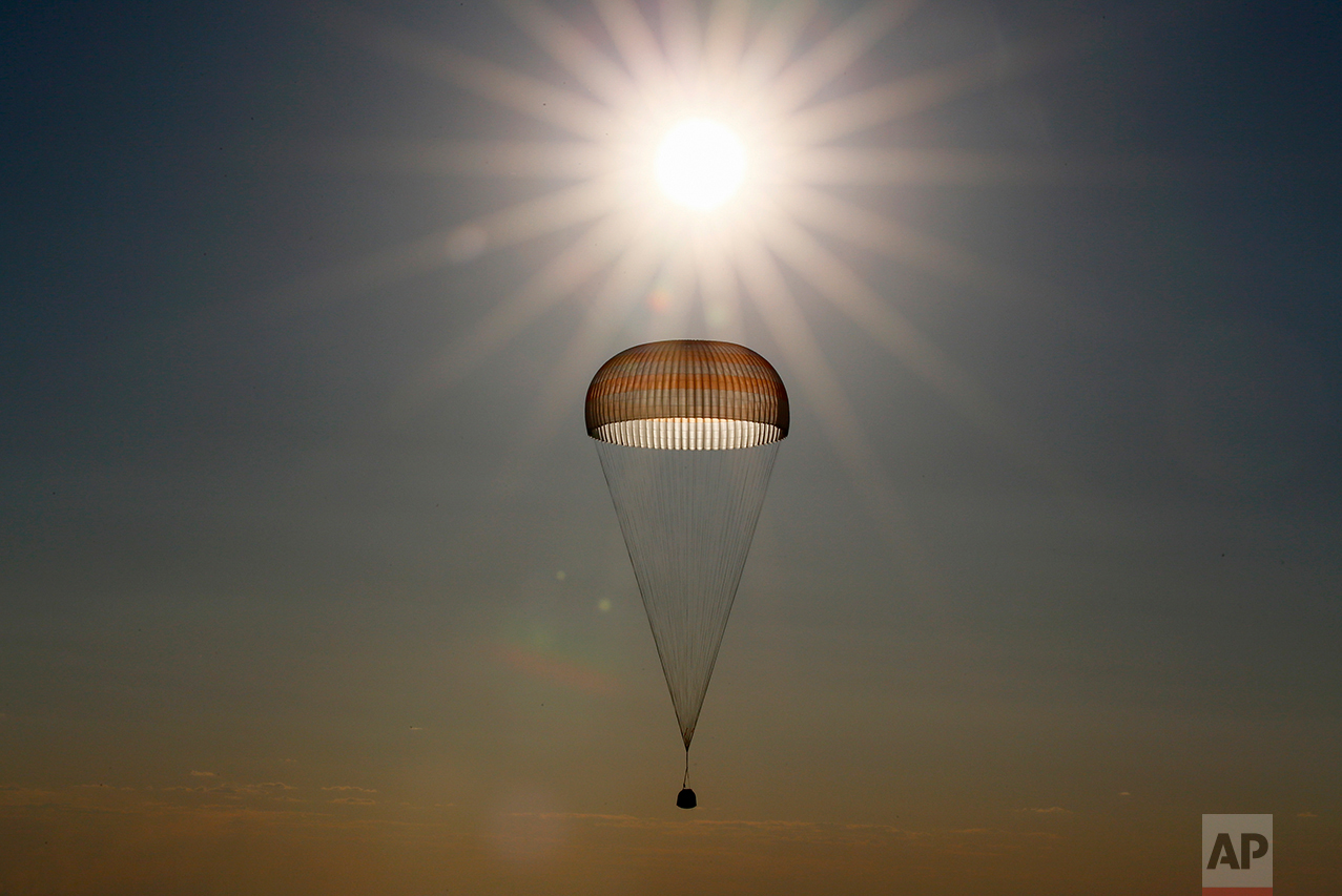 A Russian Soyuz capsule carrying Russian cosmonaut Oleg Novitsky and French astronaut Thomas Pesquet, who spent a half-year aboard the International Space Station, descends by parachute to land in a remote area outside the town of Dzhezkazgan, Kazakhstan, on Friday, June 2, 2017. (Shamil Zhumatov/Pool via AP)