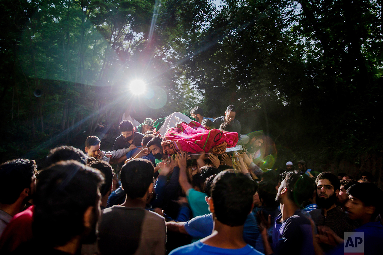 Kashmiris carry the body of rebel leader Sabzar Ahmed Bhat towards his home after displaying it to villagers in the Tral area, 45 kilometers (28 miles) south of Srinagar, Indian controlled Kashmir, on Saturday, May 27, 2017. Police said Bhat and a fellow militant were killed after troops cordoned off the southern Tral area overnight following a tip that rebels were hiding there. (AP Photo/Dar Yasin)