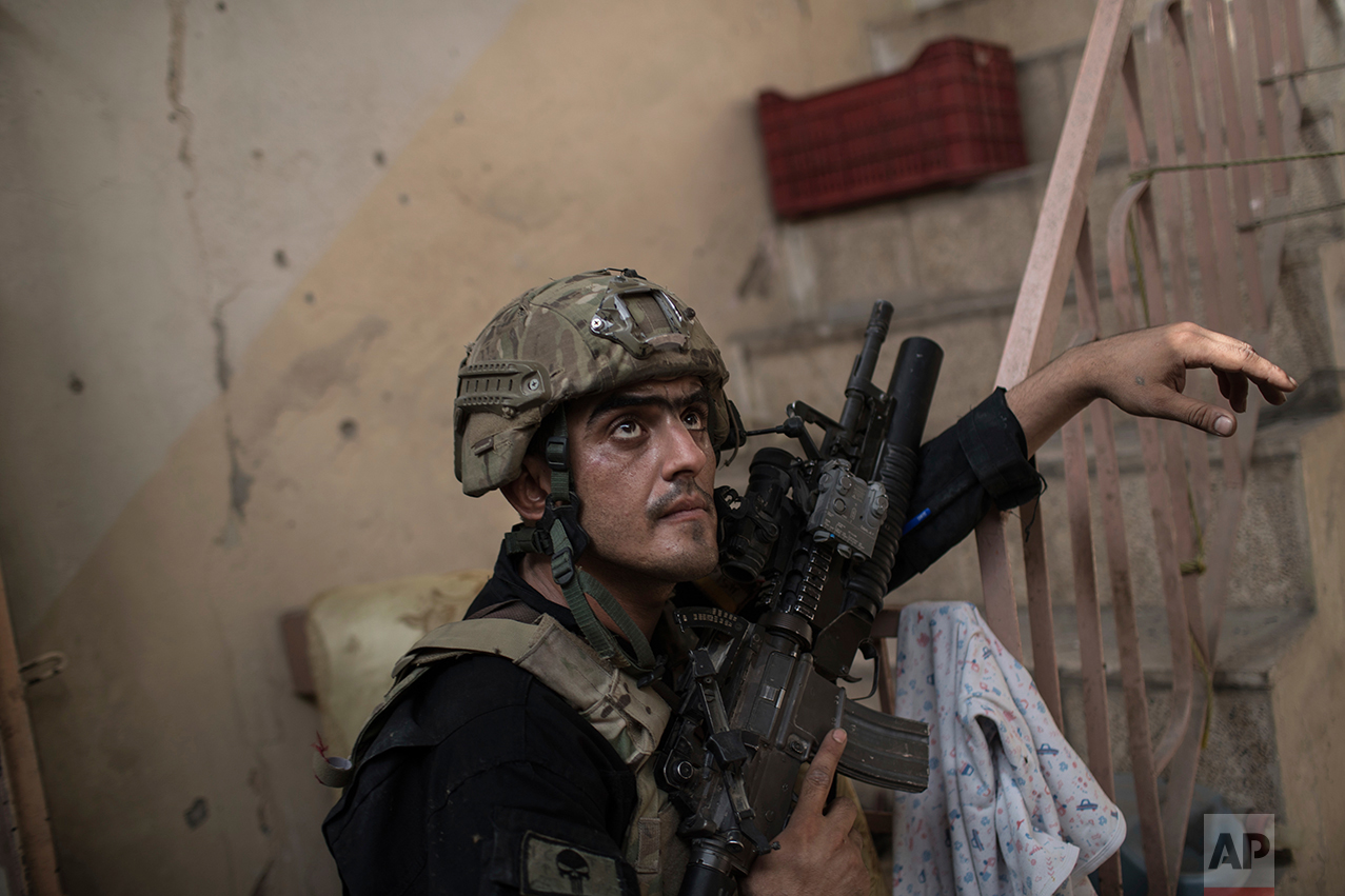 An Iraqi Special Forces soldiers watches for Islamic State militants as they continue their advance in the Old City of Mosul, Iraq, Monday, July 3, 2017. (AP Photo/Felipe Dana)