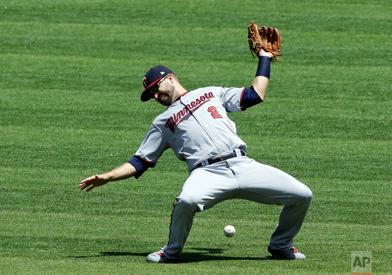 Minnesota Twins' Brian Dozier can't make the catch on a single hit by Cleveland Indians' Lonnie Chisenhall in the second inning of a baseball game, Sunday, June 25, 2017, in Cleveland. (AP Photo/Tony Dejak)