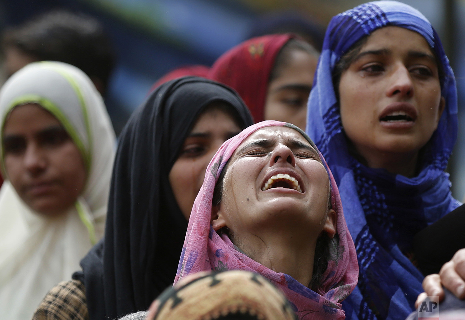 A relative cries near the body of killed rebel Jehinger Ahmad during his funeral at Keller, 49 kilometers (30 miles) south of Srinagar, Indian controlled Kashmir, Tuesday, July 4, 2017. (AP Photo/Mukhtar Khan)