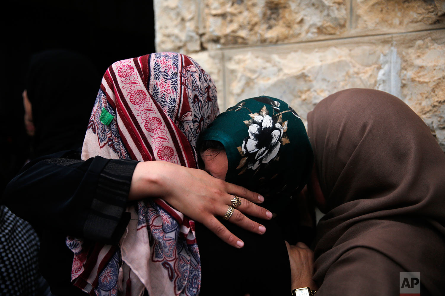 Relatives mourn during the funeral of  Mohammad Jebril in the West Bank village of Tekoa, near Bethlehem, Tuesday, July 11, 2017. Jebril was shot dead Monday after a stabbing attack against Israeli soldiers at Tekoa checkpoint. (AP Photo/Nasser Shiyoukhi).