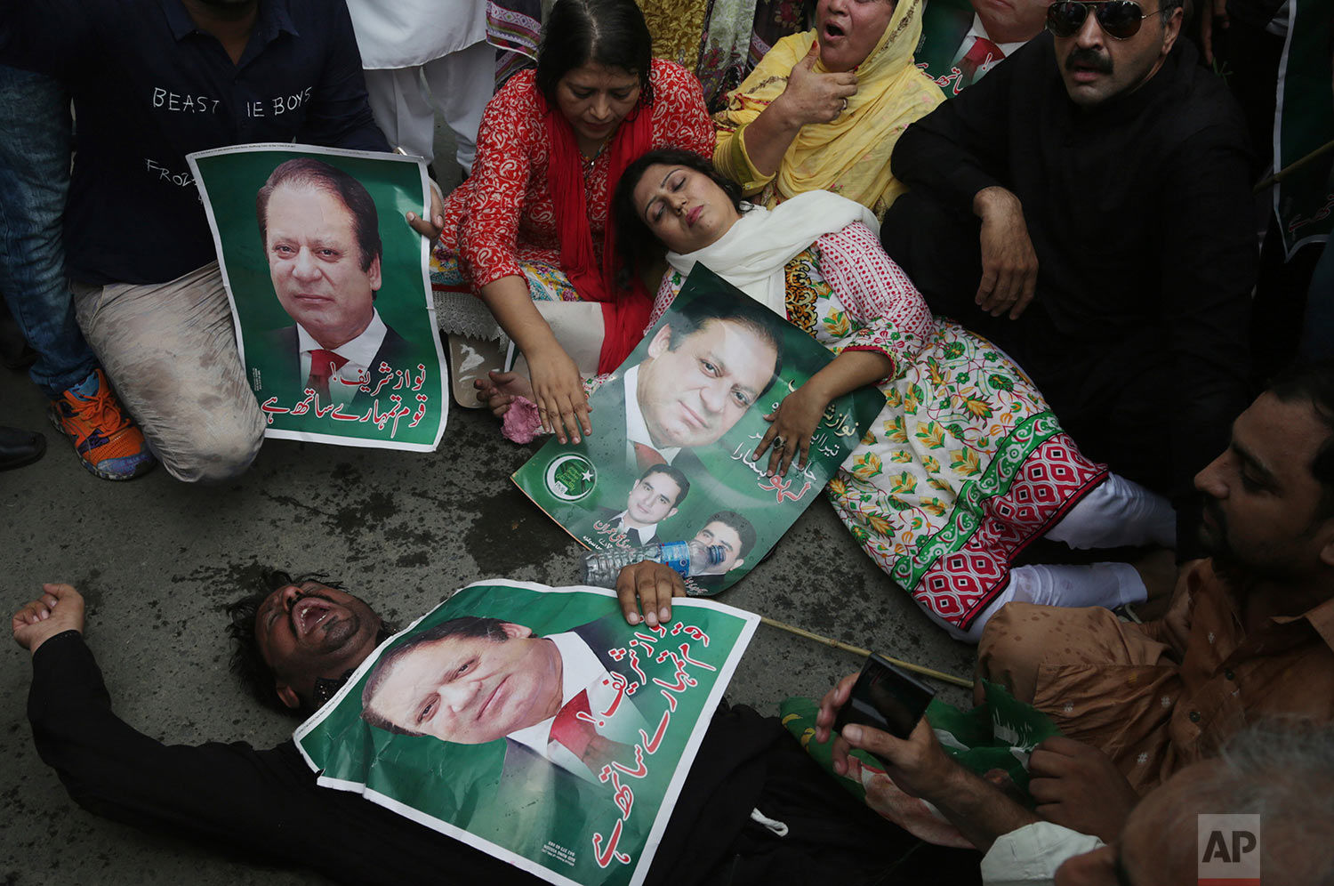 Supporters of the Pakistani ruling party Muslim League headed by Nawaz Sharif gesture during rally to condemn the dismissal of their leader in Lahore, Pakistan, Pakistan, Friday, July 28, 2017. Pakistan's Supreme Court in a unanimous decision has asked the country's anti-corruption body to file corruption charges against Sharif, his two sons and daughter for concealing their assets. (AP Photo/K.M. Chaudary)