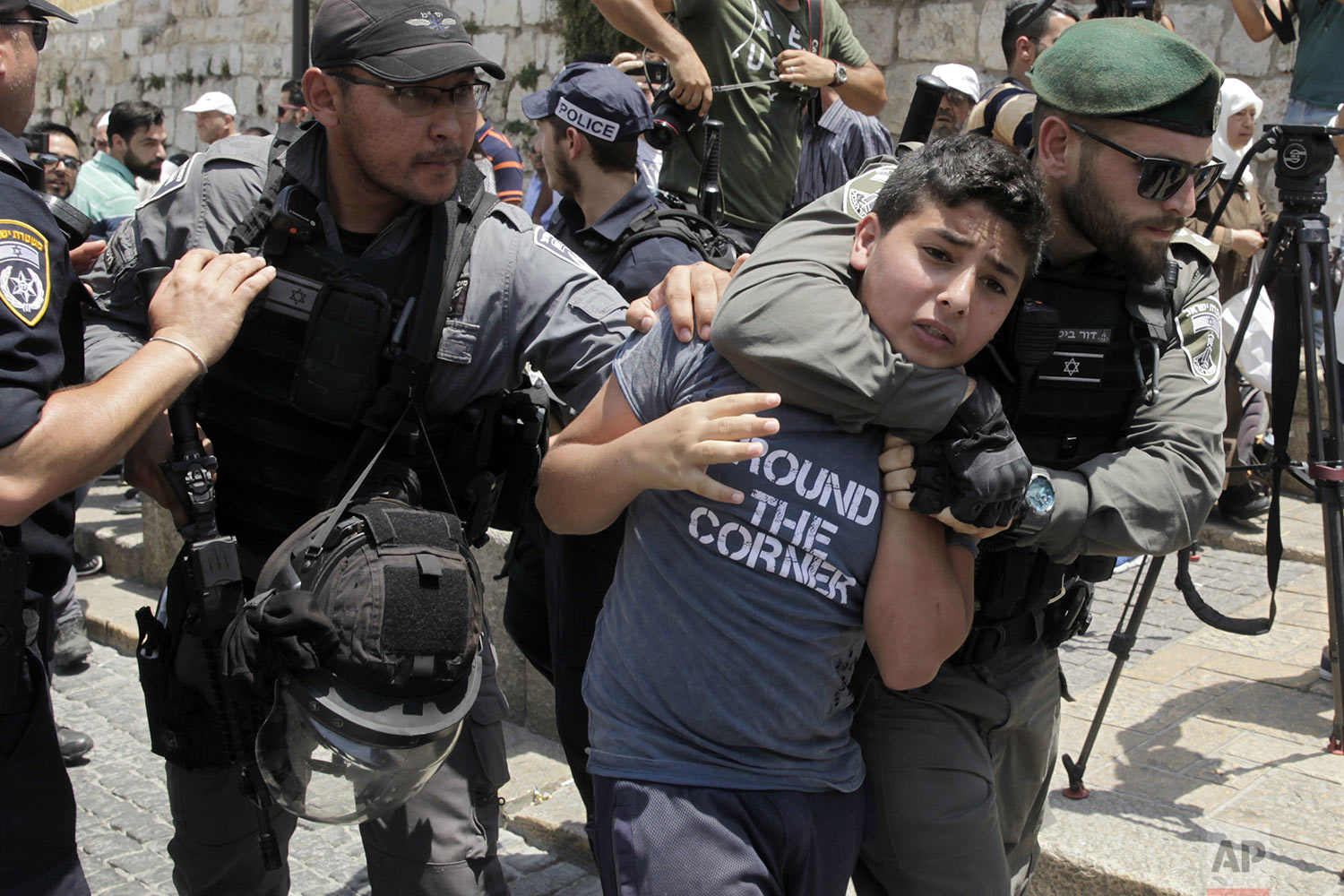 Israeli border police officers detain a Palestinian youth in Jerusalem's Old City, Monday, July 17, 2017.(AP Photo/Mahmoud Illean)